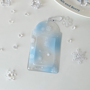 Detail of blue gradient PVC card holder with white snowflake patterns and bead chain