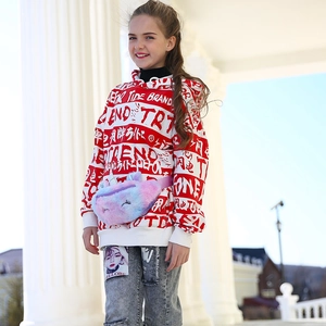 Close-up of rainbow plush unicorn waist bag styled with girls' hooded street wear