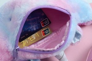Macro shot showing internal storage capacity and purple zipper of unicorn plush waist bag
