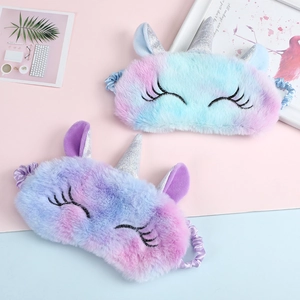 Detailed view of colorful plush unicorn sleep masks with silver glitter horn and eyelashes