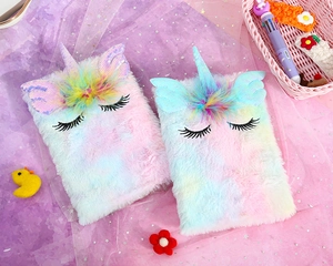 Close-up of unicorn plush notebook with gradient fur, sequins, and embroidered details