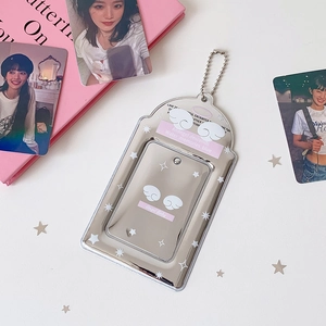 Detail of silver mirror photocard holder with angel wings and metal ball chain
