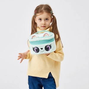 Close-up of a mint green plush cartoon cosmetic bag with unicorn eyes and soft handles