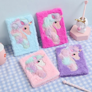 Plush unicorn notebook set in pink, purple, and blue with rainbow embroidery details