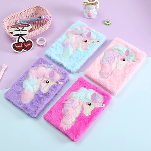 Detail of four colorful plush unicorn notebooks with soft faux fur and delicate embroidery