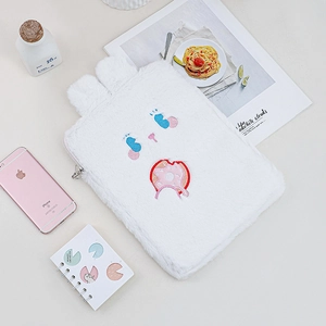 Detail of plush white 11 inch iPad sleeve with cute rabbit ears and cartoon embroidery