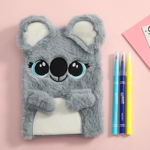 Close-up of cute grey plush koala notebook with soft fur and embroidered facial details