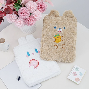 Close-up of cute plush 11-inch iPad sleeve with teddy bear and bunny embroidery detail