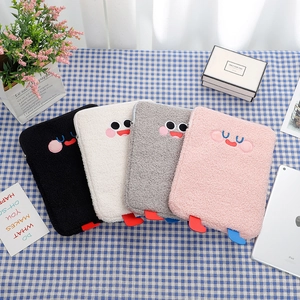 Detail of four colorful plush laptop sleeves with cute embroidered eyes and 3D feet