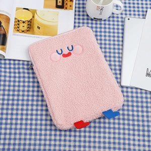 Detailed close-up of pink plush tablet sleeve with cute embroidered cartoon face design