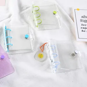 Detailed view of colorful PVC mini 3-ring glitter binders for journaling and card collecting