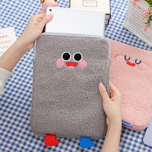 Close-up of cute plush iPad sleeve with soft fleece texture and cartoon embroidery