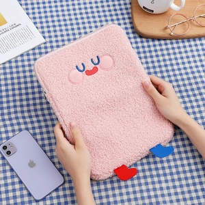 Detail of pink teddy fleece tablet sleeve with cute cartoon embroidery and small 3D legs