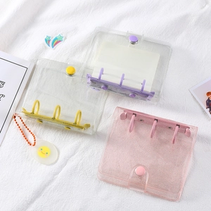 Three mini PVC 3-ring binders in pink glitter, yellow, and purple for photo card storage