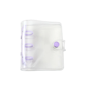 Macro detail of clear PVC mini binder with purple three-ring clip and snap closure