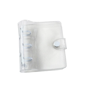 Detail of transparent glitter PVC binder with 3-ring mechanism and snap button closure