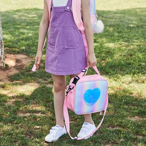 Detail of pink glitter lunch bag featuring a blue sequin heart and adjustable strap