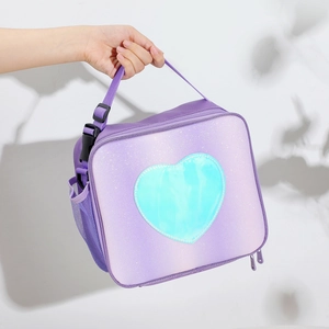 Close-up of glitter purple lunch bag featuring a shiny blue heart and side mesh pocket
