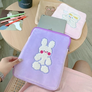 Close-up of cute cartoon animal embroidery on colorful plush tablet storage sleeves