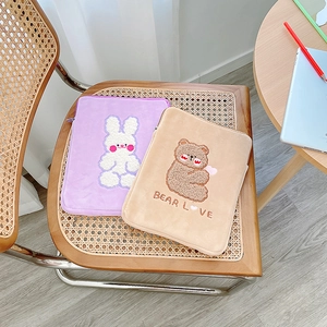 Detail of plush iPad sleeve featuring cute cartoon rabbit and bear embroidery designs