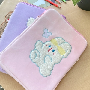 Detail of plush laptop sleeves with cute rabbit towel embroidery in pink and purple colors