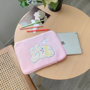 Close-up of pink plush iPad sleeve with cute white bear embroidery and soft texture