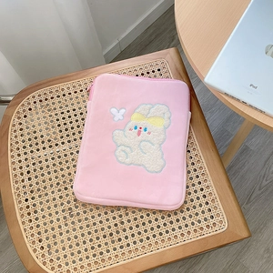 Detailed view of pink plush tablet sleeve with cute white bunny embroidery and zipper