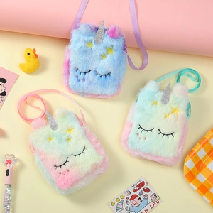 Close-up of plush unicorn crossbody bags with embroidery and glitter horns details