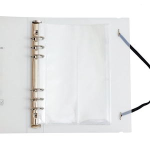 Detail of A5 frosted binder showing 6-hole metal ring mechanism and transparent inner pocket