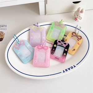 Set of six colorful acrylic card photo holders with bead chains displayed on a plate