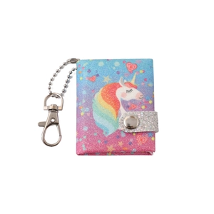 Detail of mini unicorn keychain notebook with glitter finish and metal button closure