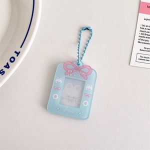 Detail of light blue acrylic photo card holder with pink bow and cartoon bunny motifs