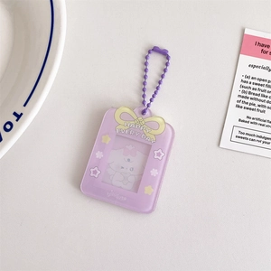 Detail of purple acrylic photo card holder with yellow bow and beaded metal chain
