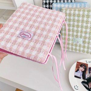 Macro detail of A5 photocard binder showing pink tweed fabric and ribbon tie closure