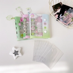 Detailed view of PVC 3-hole binder albums with cute clover and floral patterns