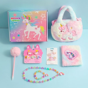 Detailed view of unicorn plush diary, handbag, and jewelry set in a surprise gift box