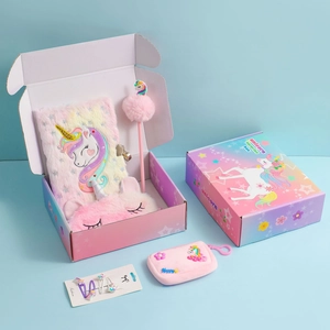 Plush unicorn stationery gift set including a furry notebook, eye mask, and pink accessories