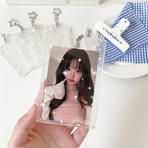 Close-up of clear acrylic photocard holder with star pattern and star-shaped keychain