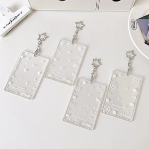 Detail of transparent acrylic card holders with star charms and printed patterns