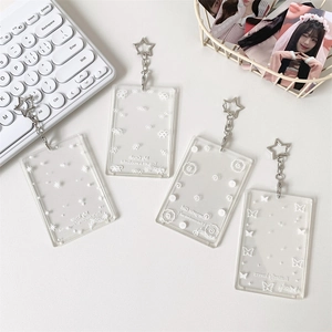Detail of four transparent acrylic photocard holders with butterfly and star prints