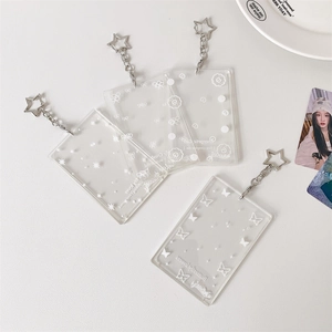 Detail of transparent acrylic card holder with star metal clasp and butterfly prints