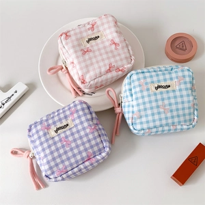 Three-piece set of square checkered cosmetic bags in macaron colors with pink bow details