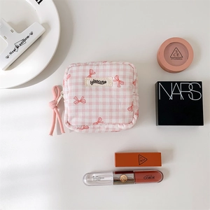 Pink checkered aesthetic cosmetic pouch with bow pattern and zip closure for makeup