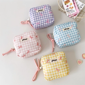 Set of four gingham check cosmetic pouches with cute pink bows in pastel macaron colors