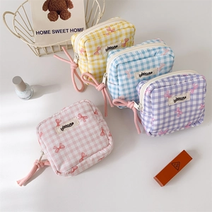 Checkered makeup bags in pastel colors with pink bow patterns and zipper closure