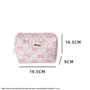 Detailed view of pink quilted bow cosmetic bag with dimensions 19.5 x 14.5 x 9 cm