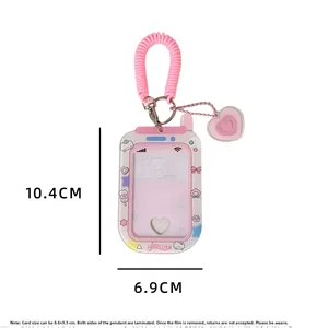 Detailed view of cute pink phone-shaped photocard holder with elastic strap and heart charm