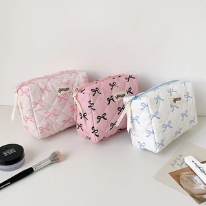 Quilted bow makeup bags in pink and white, spacious travel pouches for cosmetics and toiletries