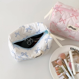 Quilted cotton cosmetic bags with bow patterns in a two-piece set for storage