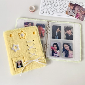 Detail of plush yellow photocard album with ribbon ballet style and star cutout window